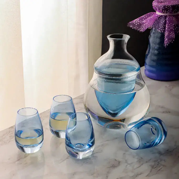 Clear glass wine pot with distinctive blue-tinted interior and matching blue-rimmed glasses for wine pot ice use