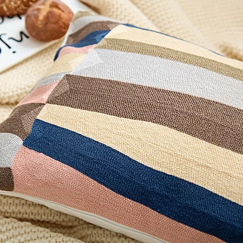 A cozy embroidered geometric cotton cushion cover with wide diagonal stripes in beige navy blue pink and brown