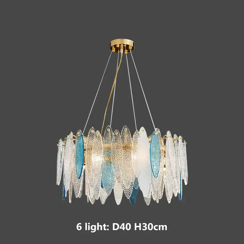 A modern pendant light with a decorbites gold metal chain and hanging clear, white, and blue glass discs