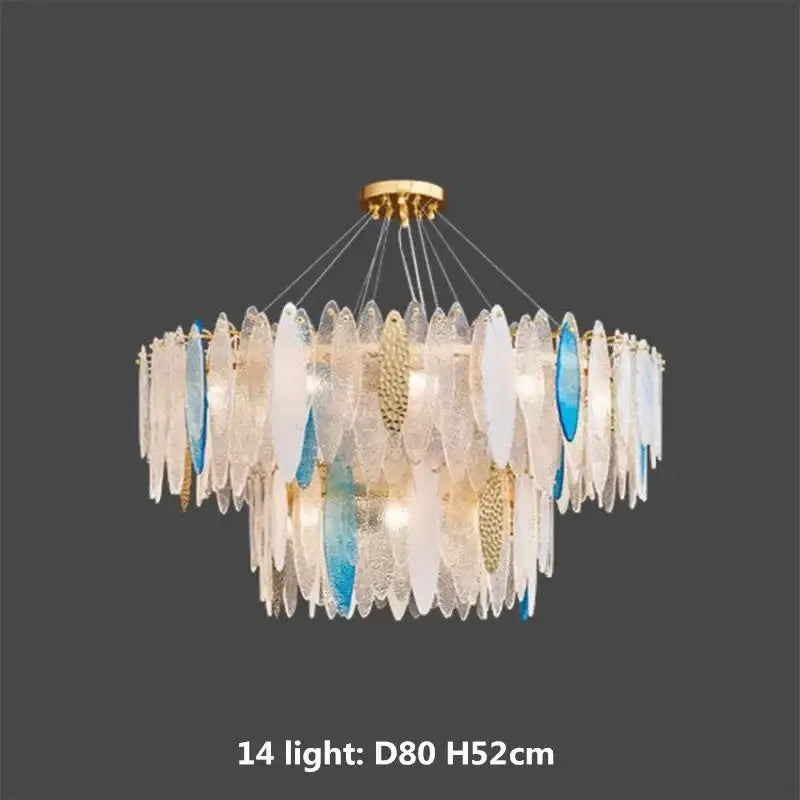 A modern pendant light with blue and white leaf glass shades suspended by a decorbites gold metal chain fixture