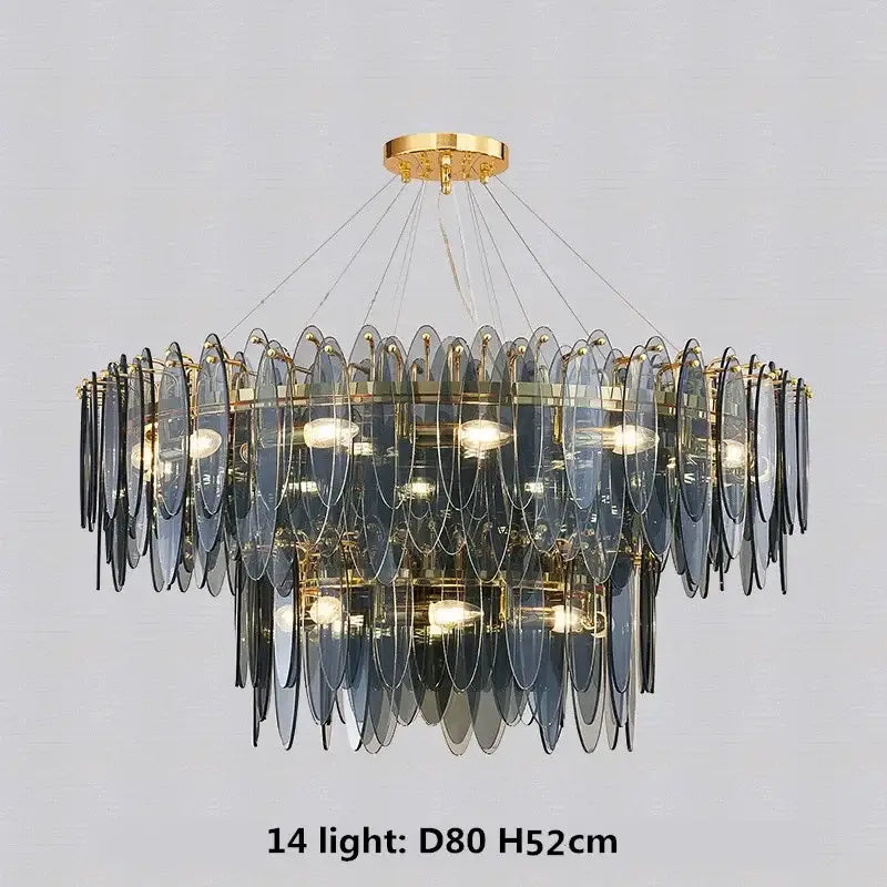 A modern pendant light with cascading blue glass discs and gold metal chain decorbites gold metal framing