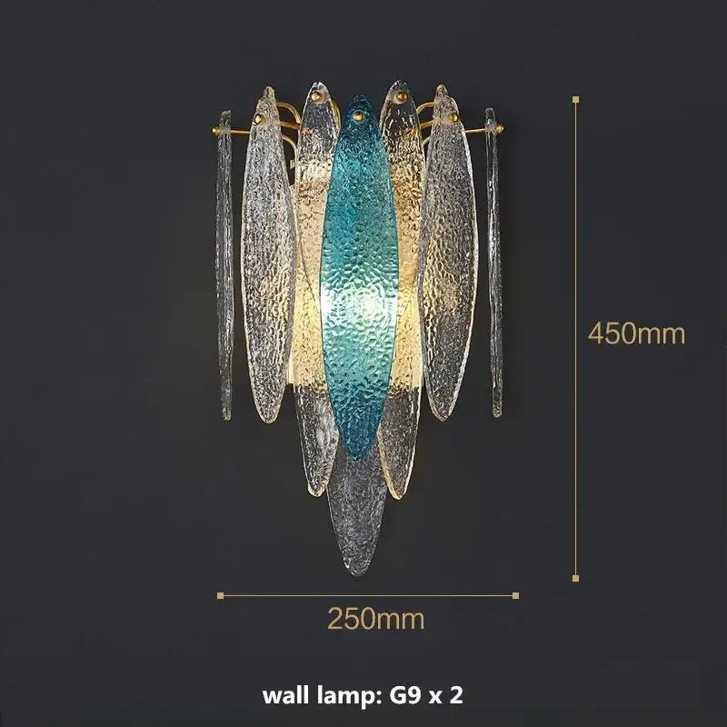 A modern wall lamp with teal and gold glass fish paired with modern blue and white leaf pendant lights with gold metal chain decorbites gold metal