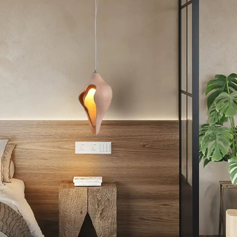 A modern blush pink ceramic pendant light with a shell-shaped design for dining room decorbites conch chandelier