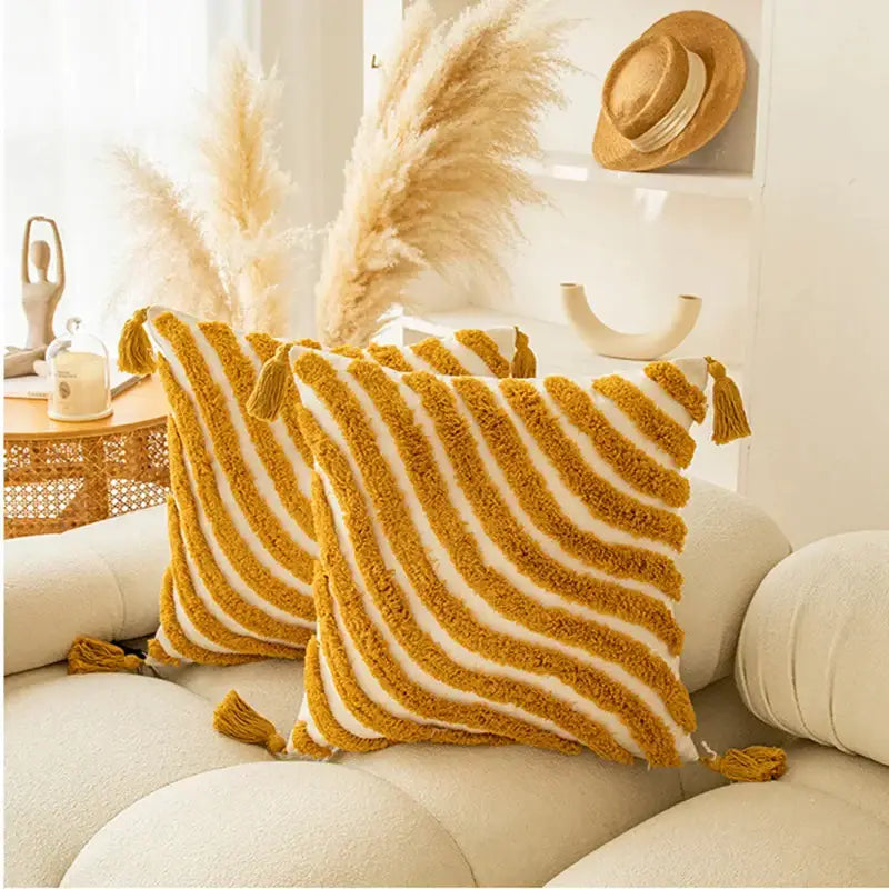 Mustard yellow and cream striped textured cushion cover with tassels featuring decorbites golden yellow geometric design