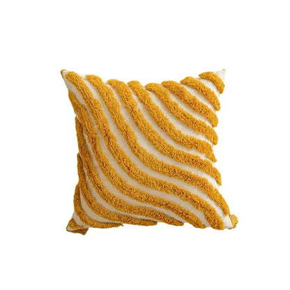 A cozy cushion cover with bold mustard yellow and cream geometric tufted tassel stripes in plush woven fabric