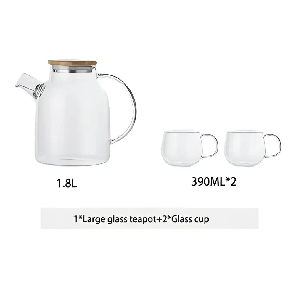 Modern borosilicate glass teapot with wooden lid and handle and two matching transparent borosilicate glass cups for tea set
