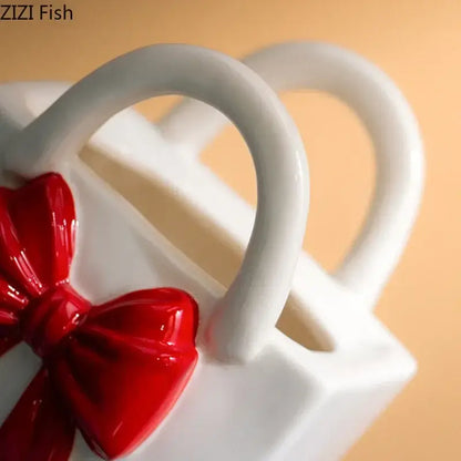 White ceramic ceramic vase handbag with glossy red bow accent for modern decorbites bowknot ceramic decor