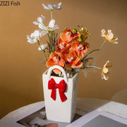 White ceramic decorbites bowknot ceramic vase shaped like a handbag with red bow handle for living room decor