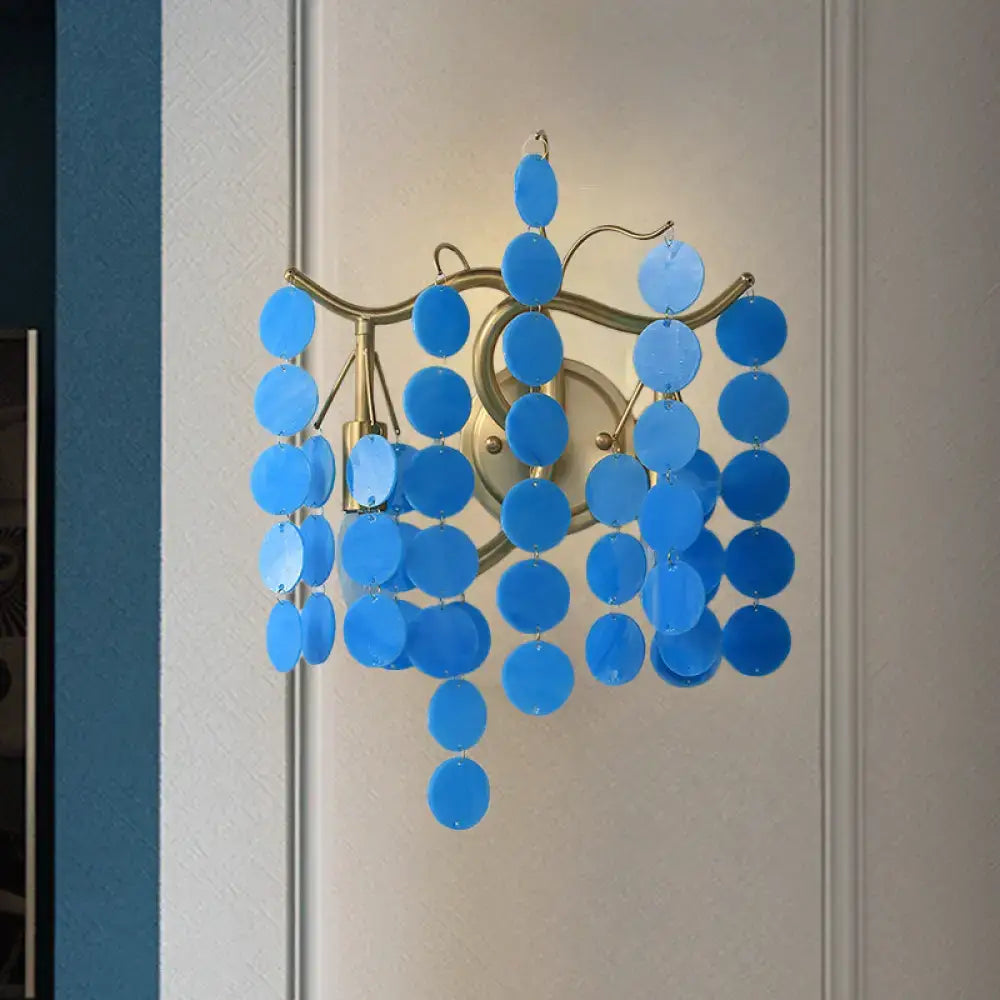 Modern branch design wall lamp featuring blue circular glass discs on a gold-toned metal frame for bedroom use