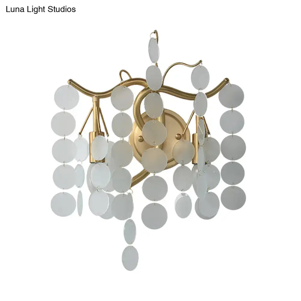Gold-toned wall lamp with branch design featuring cascading white translucent discs for branch design bedroom use