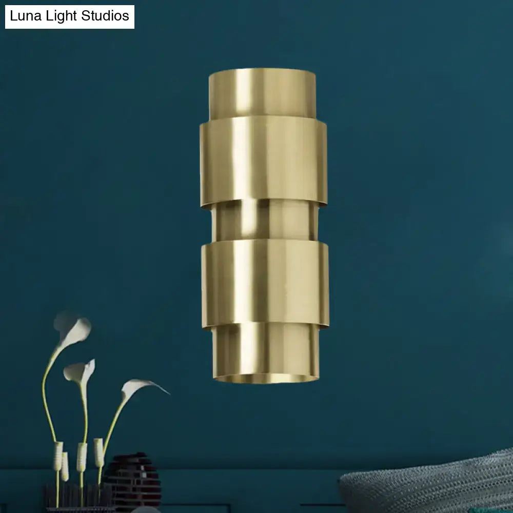 Modern brass 3 tier metal shade wall sconce with a brass-toned tiered cylindrical design for foyer lighting