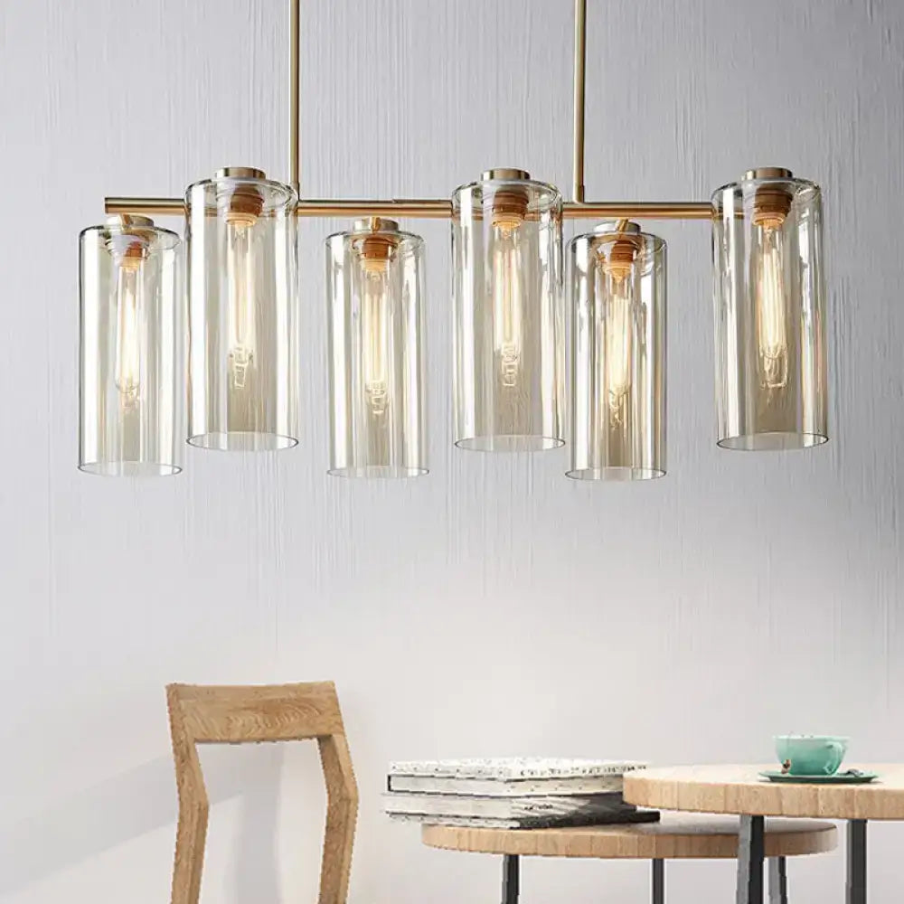 Modern brass 5 light chandelier with cognac glass shades and exposed bulbs perfect for dining room island light