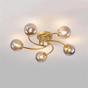 Modern brass 5-light ceiling light fixture with curved arms and frosted glass bulbs for kitchen lighting