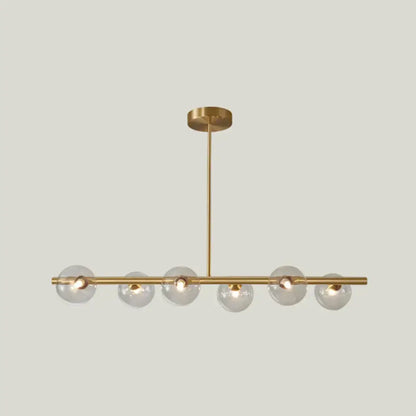 Modern brass pendant light with six clear spherical glass shade bulbs in a linear design for dining room use