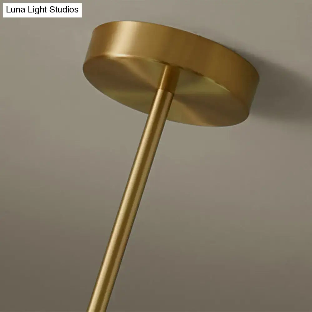 Modern brass 5-light pendant light with gold-finished brass ceiling fixture and spherical glass shade for dining room