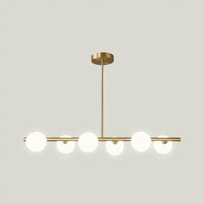 Modern brass 5-light pendant light with gold-toned spherical glass shade globes for dining room lighting