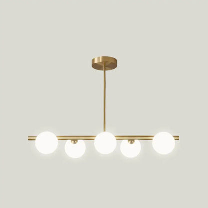 Modern brass 5-light pendant light with spherical glass shade featuring frosted glass globes in linear design