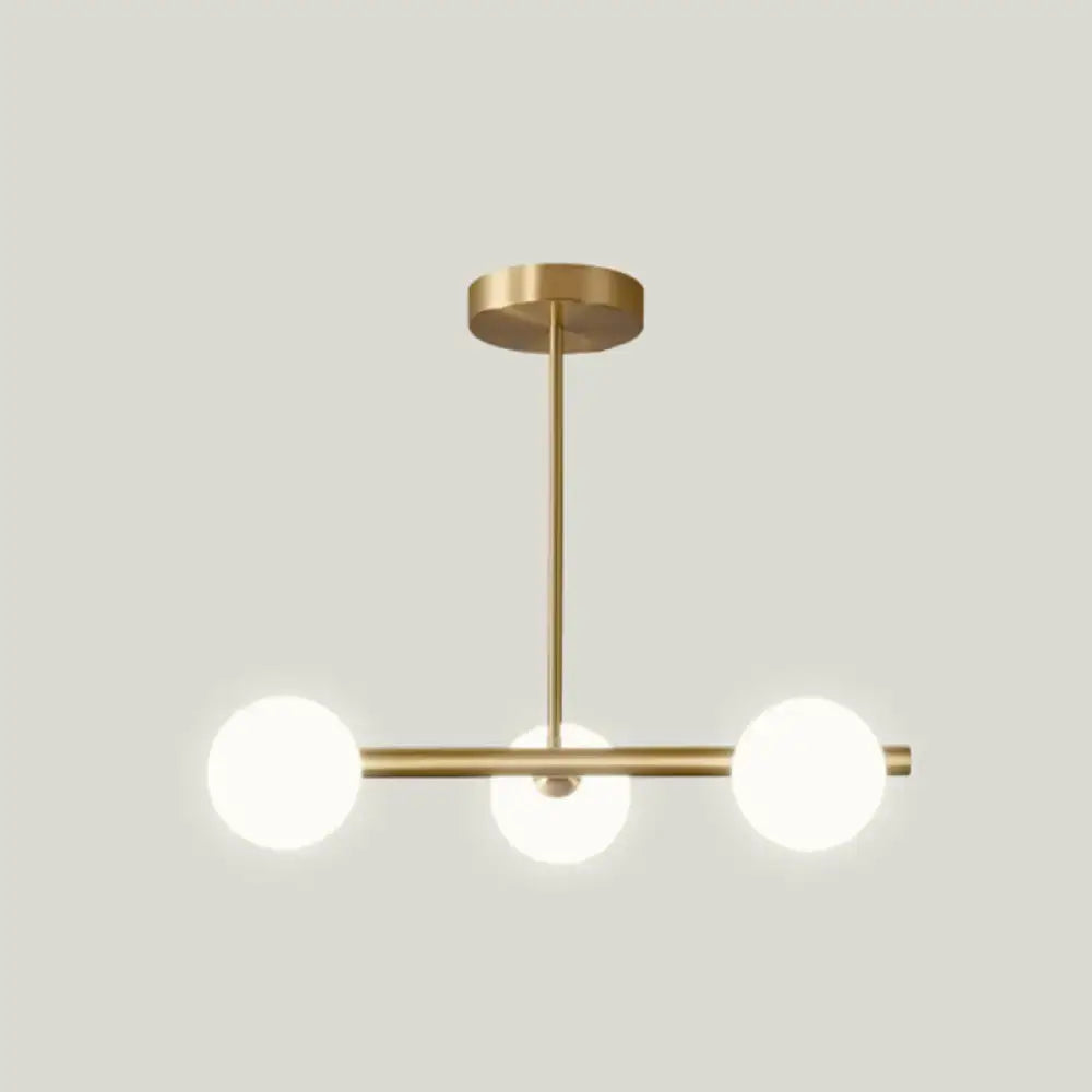 Modern brass pendant light with three frosted spherical glass shade bulbs for dining room lighting
