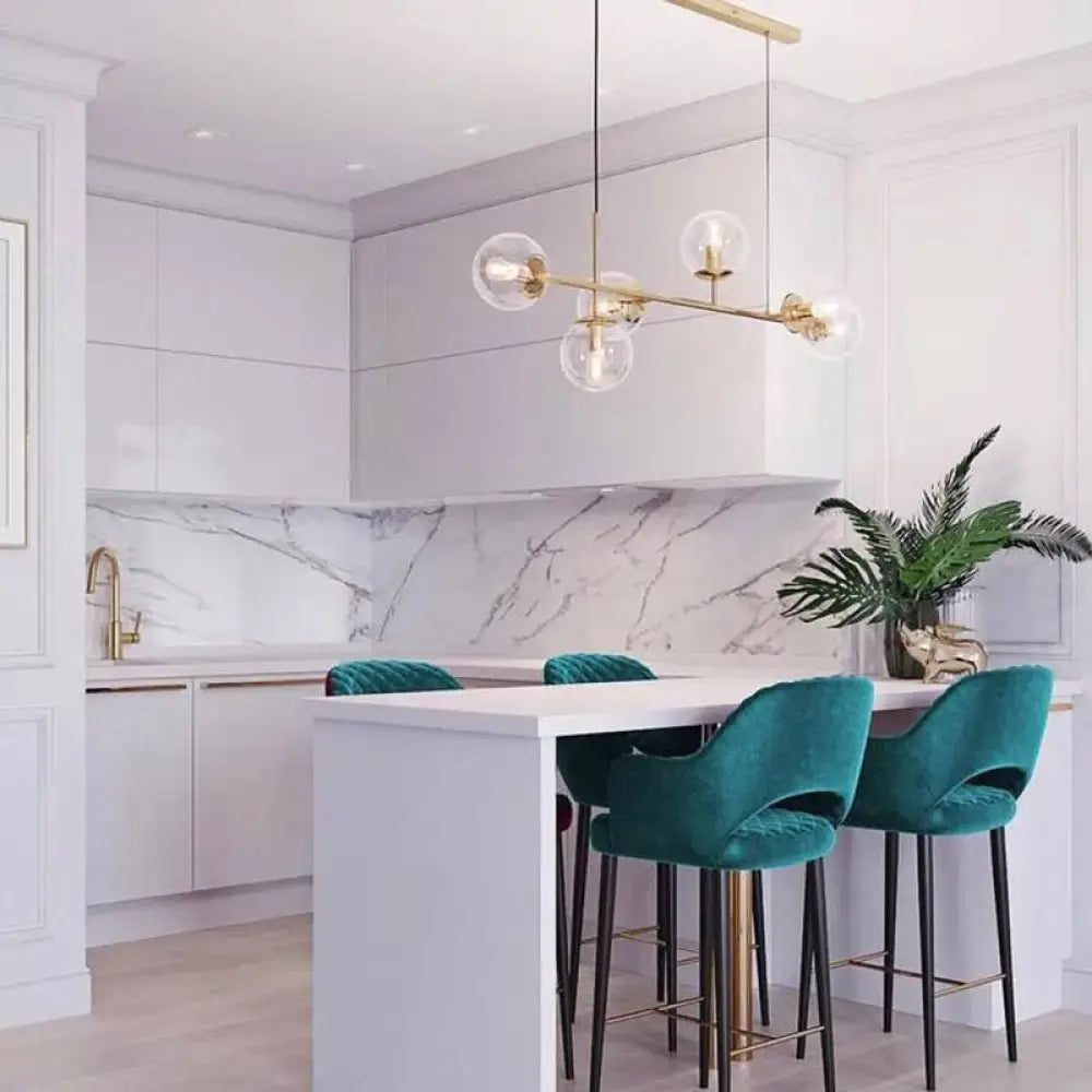 Teal velvet bar stools with black legs and gold-tone metal accents shown beside a modern brass 6-bulb island lamp with glass shade for dining rooms compatible with 110v-120v 220v-240v