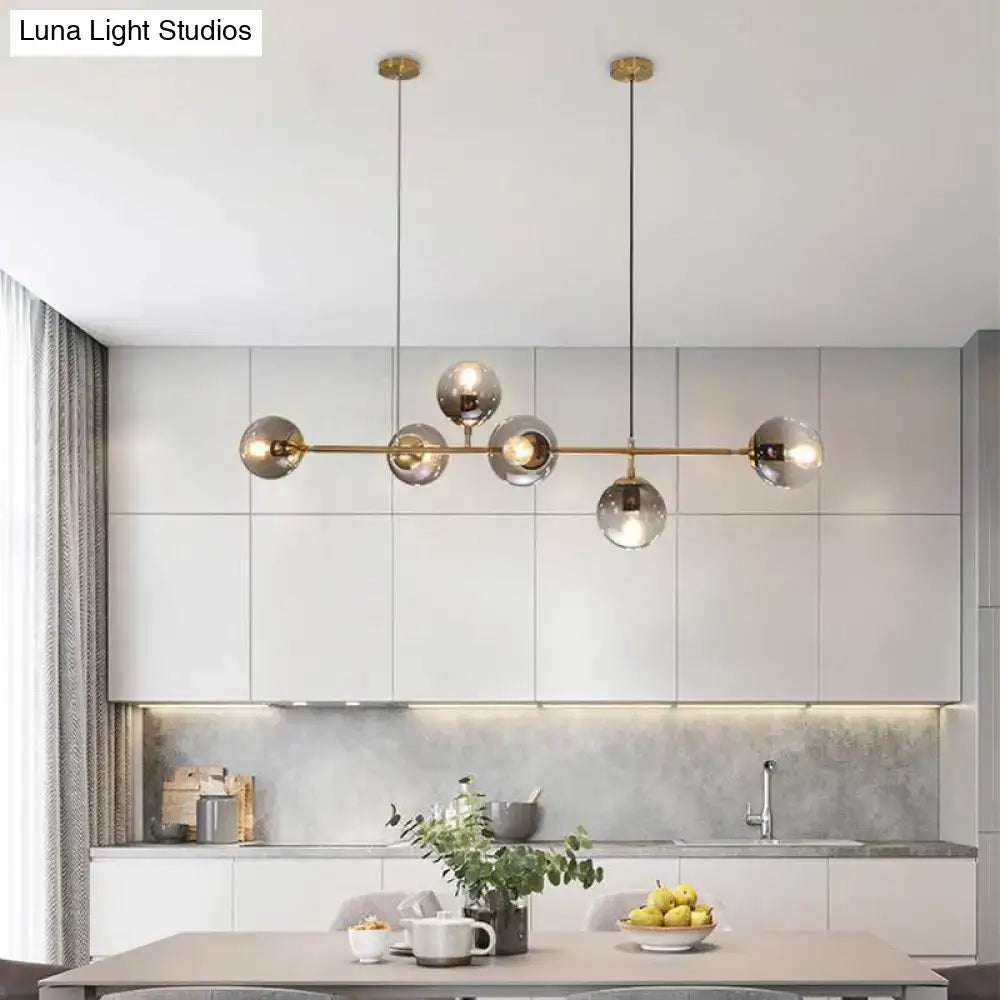 Modern brass island lamp with six 110v-120v glass shade bulbs featuring five smoked glass globes for dining rooms
