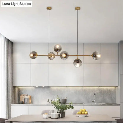 Modern brass island lamp with six 110v-120v glass shade bulbs featuring five smoked glass globes for dining rooms