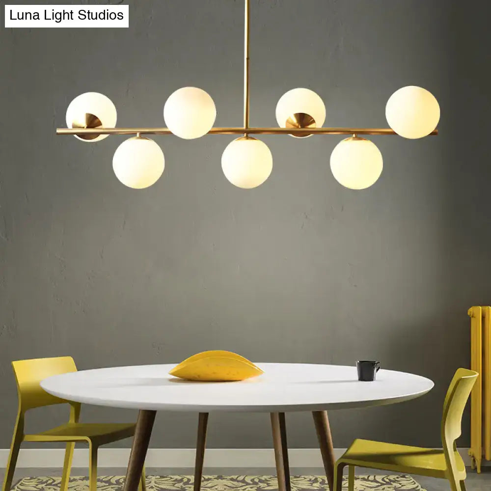 Decorbites sleek cream glass spherical dining room pendant light with seven gold heads and frosted globes
