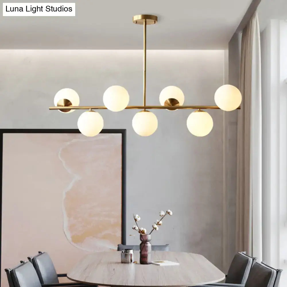 Decorbites sleek brass pendant light with six frosted glass globe bulbs for modern spherical dining room lighting