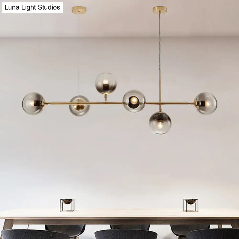 Modern brass 6 light dining room pendant chandelier with smoke gray glass shades and a central rod suspension