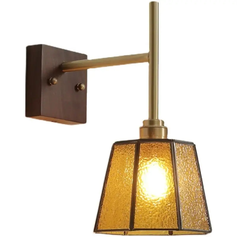Modern brass wall lights featuring textured amber glass copper led shade and dark wood mounting plate for bedroom sconce