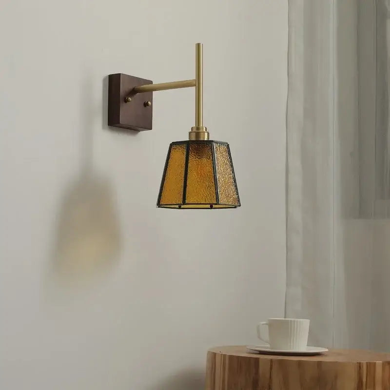 Modern brass wall lights featuring a textured amber glass copper led shade for bedroom sconce lighting