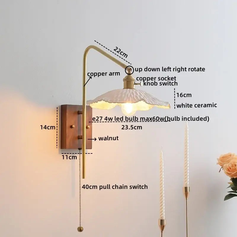 A vintage-style wall light with brass copper led arm, walnut plate, and white ceramic shade for bedroom sconce lighting