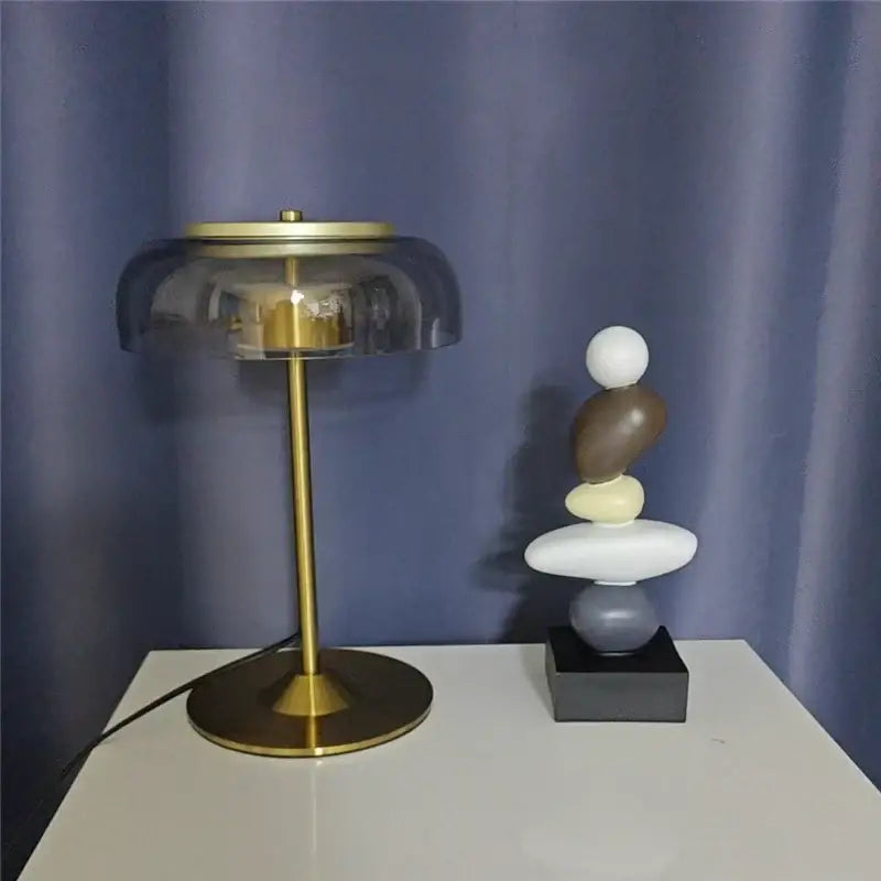 Modern brass table lamp with an elegant mushroom glass smoked amber shade for stylish bedroom decorbites lighting