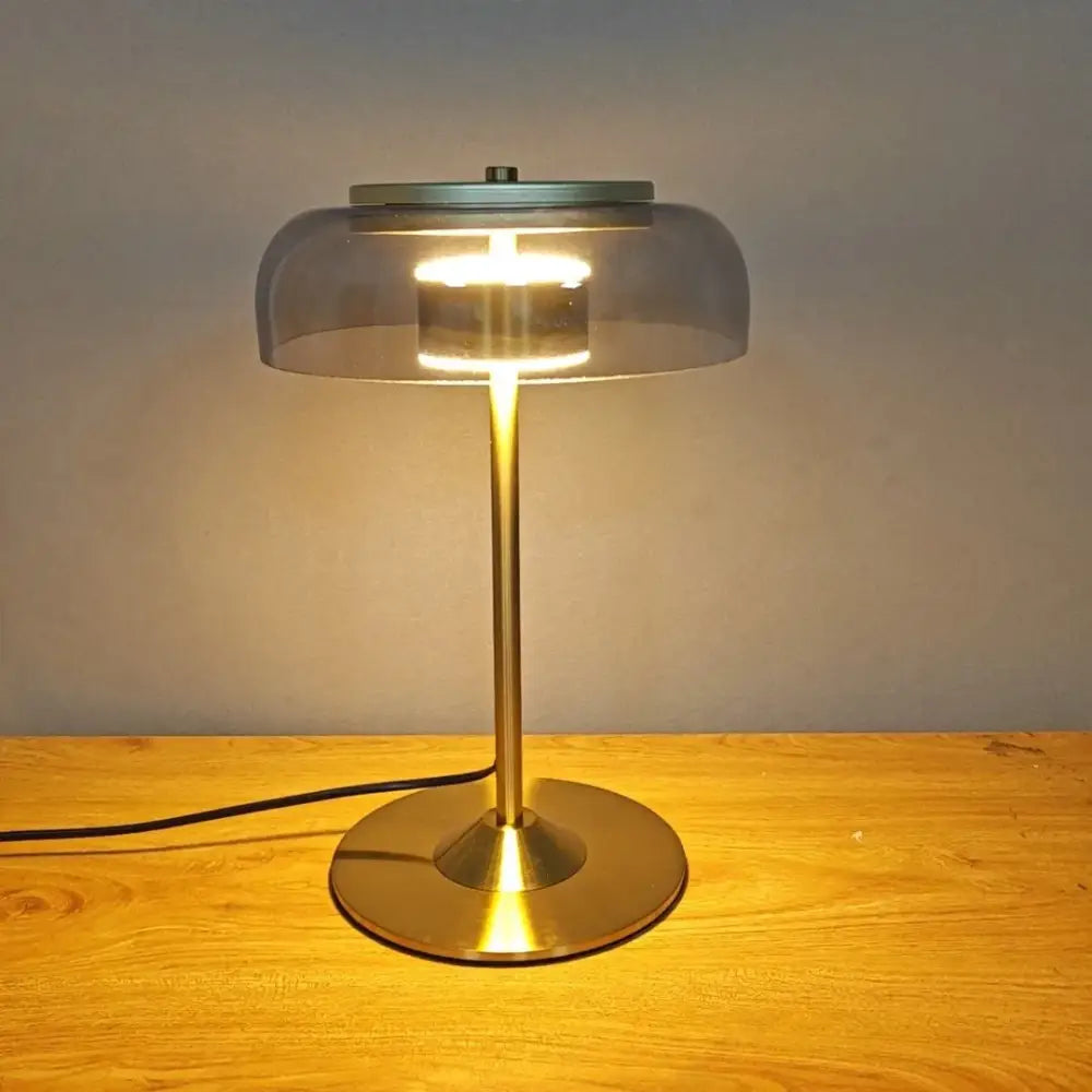 Modern brass table lamp with translucent gray glass dome and circular base for decorbites elegant mushroom glass decor