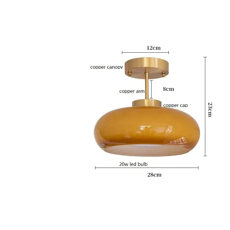 A sleek amber glass pendant light with polished copper bauhaus led canopy and arm for modern kitchen decorbites lighting