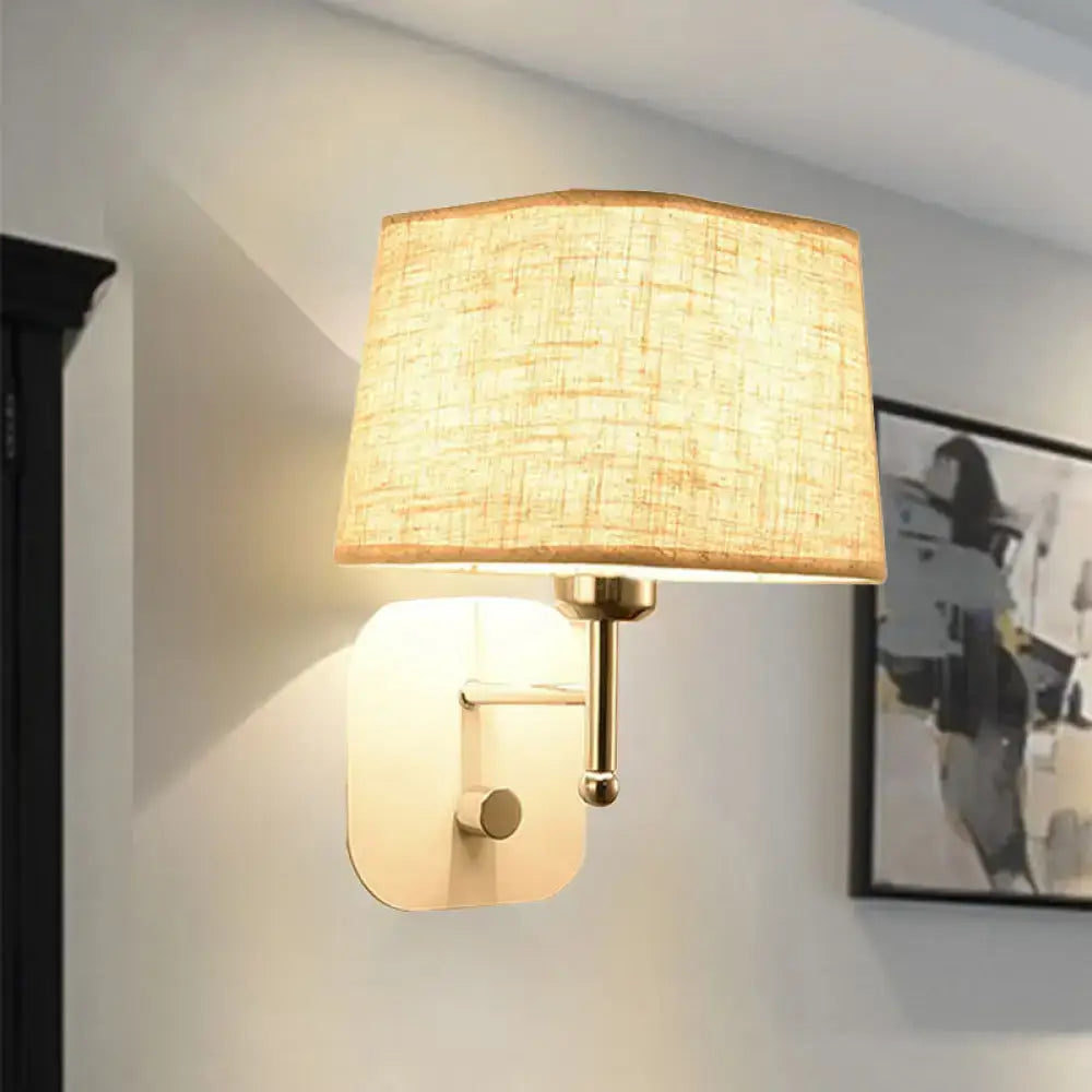 Modern brass and beige linen wall sconce lighting featuring a warm-toned rectangular fabric shade with textured finish