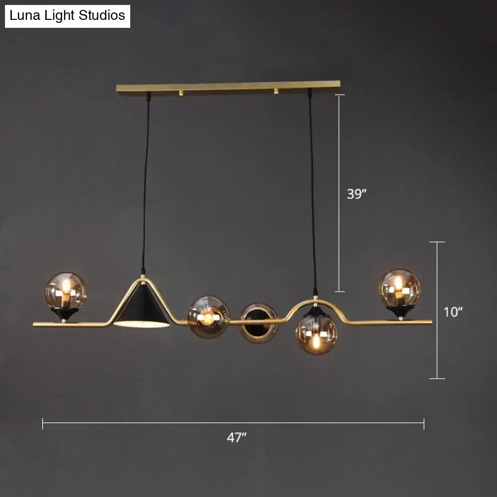 Modern brass and black geometric pendant light with spherical glass bulbs in gold metal ball hanging island design