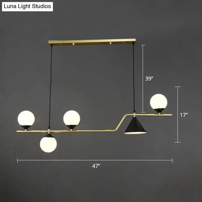 Modern brass ball hanging island light with three frosted glass globes and one black conical shade for dining room