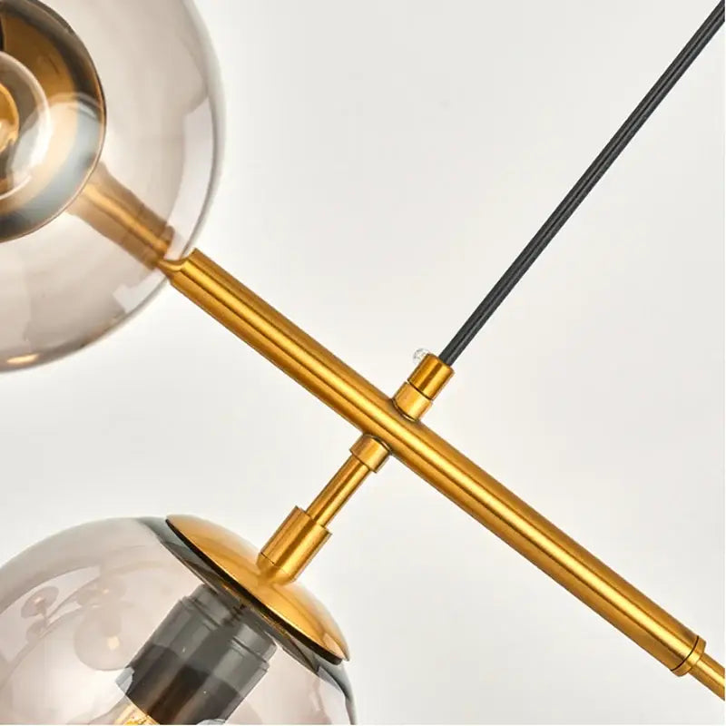 Modern brass and black art glass ball chandelier with smoked glass globe shades for living room lighting