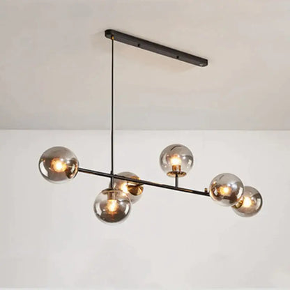 Modern brass and black art glass ball chandelier featuring six smoked glass globe bulbs in black art finish for living room lighting
