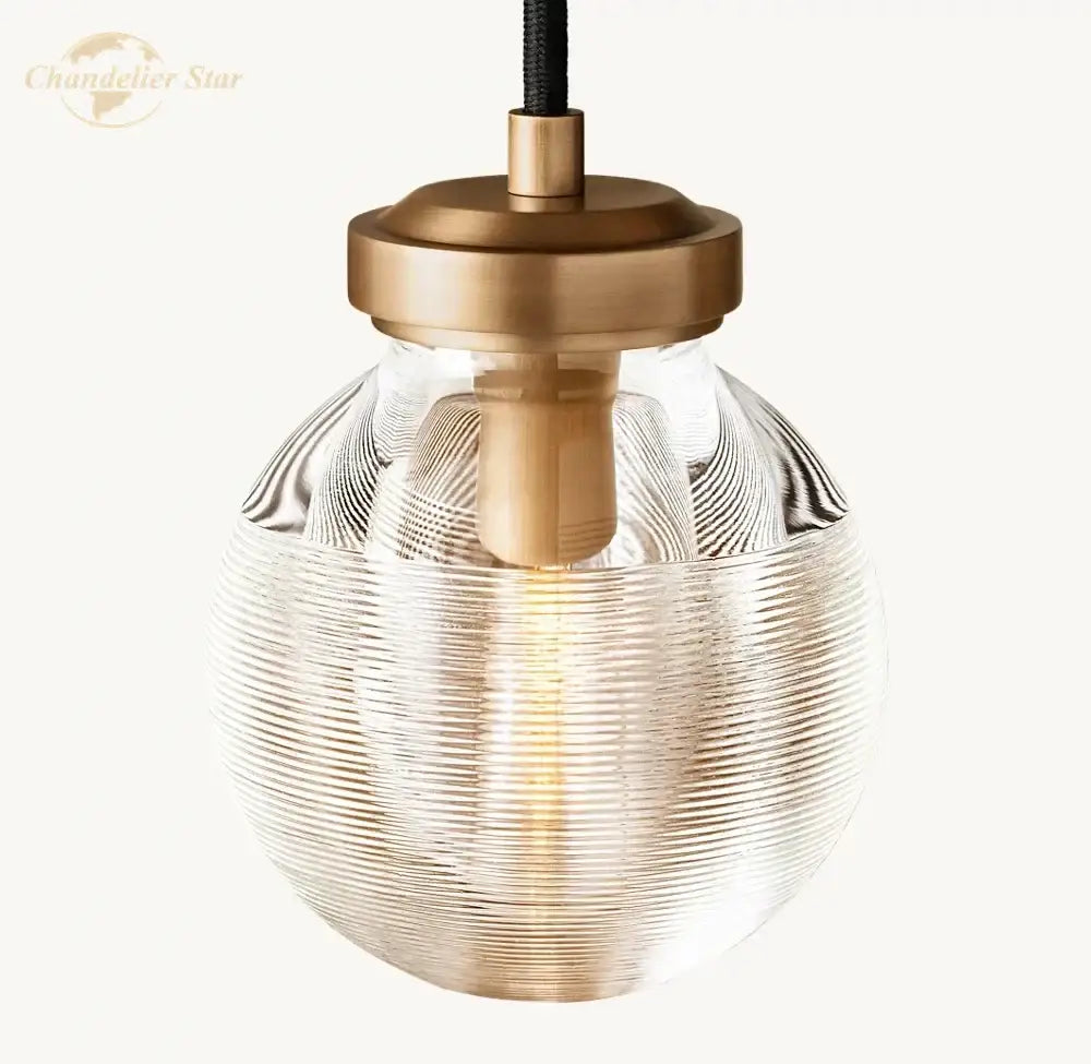 Modern brass and black crystal led wall sconce with clear ribbed glass pendant light and brass metal accents for bedroom