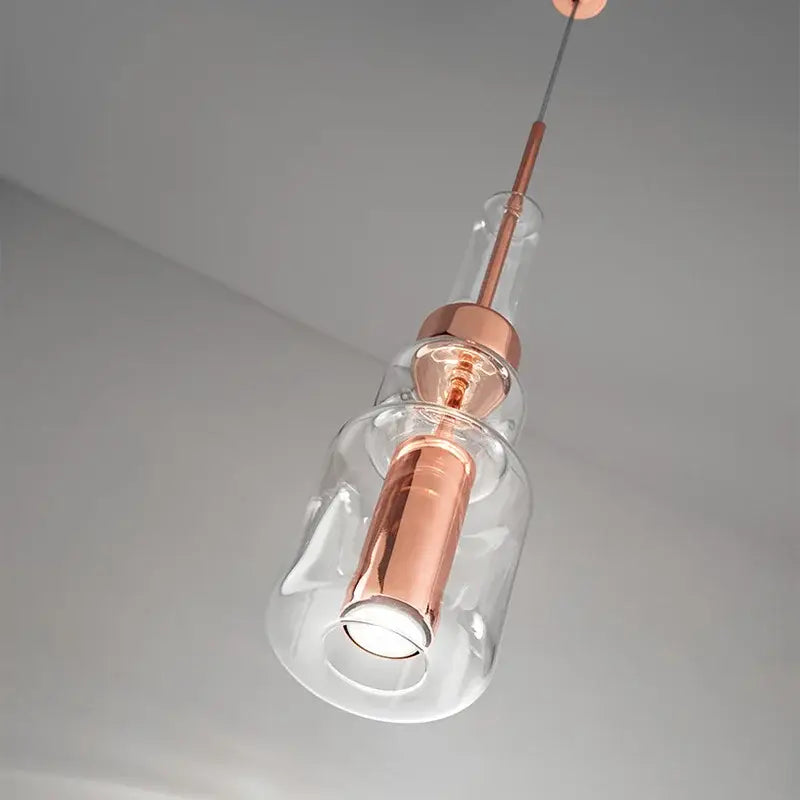 Modern brass and black cylindrical glass pendant light with copper-toned clear glass shades for kitchen decorbites cylindrical glass pendant