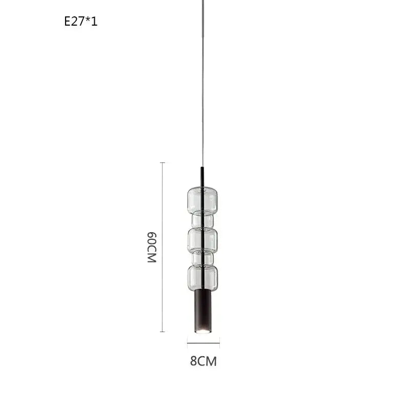 Modern brass and black cylindrical glass pendant light with three stacked clear glass cylinders for kitchens