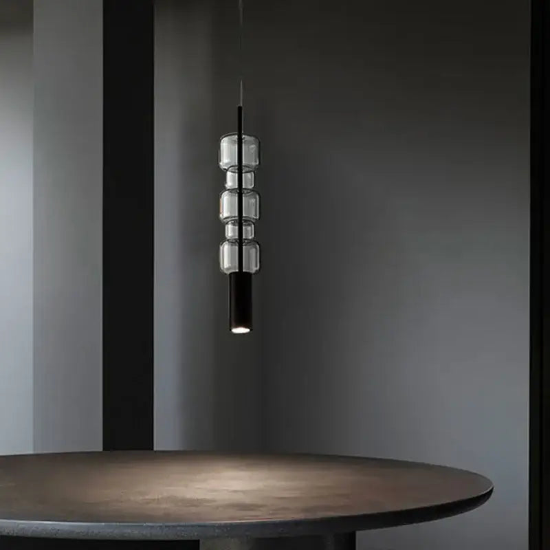 Modern brass and black cylindrical glass pendant light with decorbites cylindrical glass design for kitchen decor