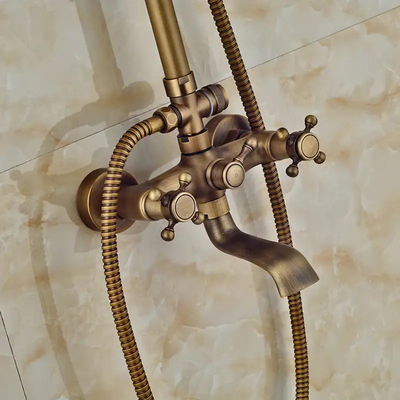 Antique brass vintage-style bathtub faucet with three cross handles and flexible hoses for modern dual handle shower faucet set