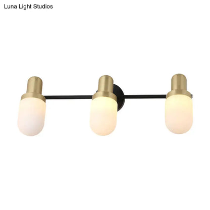Modern brass and black glass sconce light with three frosted glass shades and brushed brass accents for bedroom wall lamp