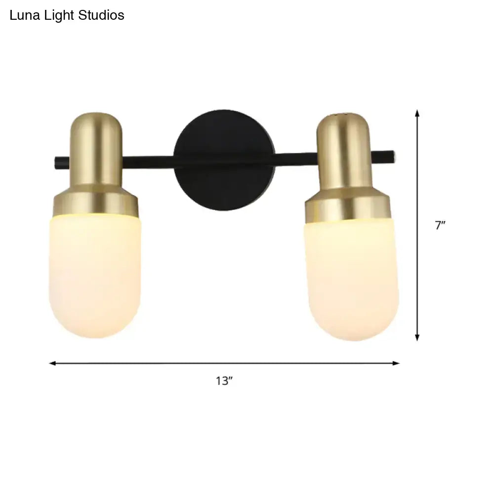 Modern brass and black glass sconce light with brushed brass fixtures and frosted glass shades for bedroom wall lamp