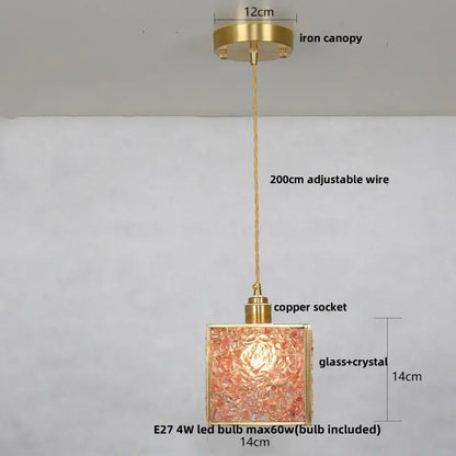 Modern brass pendant light fixture with textured amber glass and crystal shade for kitchen lighting