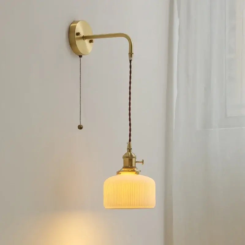 Modern brass and ceramic copper led wall lamp with warm vintage brass arm and off-white ribbed glass shade decorbites ceramic copper