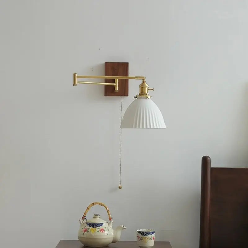 Modern brass and ceramic walnut led wall lights featuring a white ribbed ceramic lampshade on a wooden backplate by decorbites