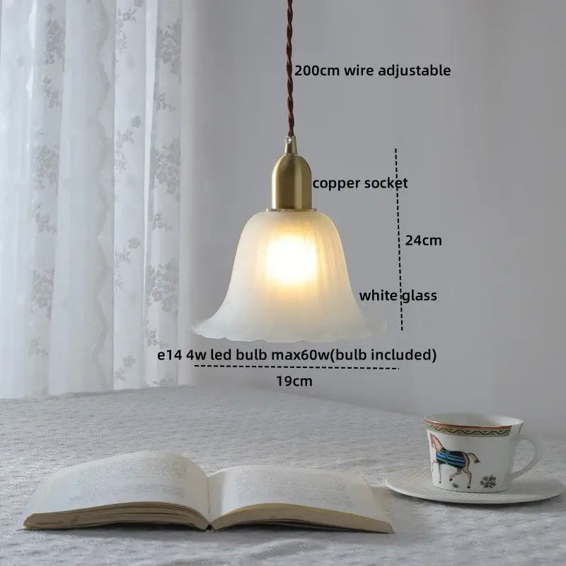 Modern brass and clear glass chandelier pendant light with warm white glass and twisted brown wire suspension for dining room